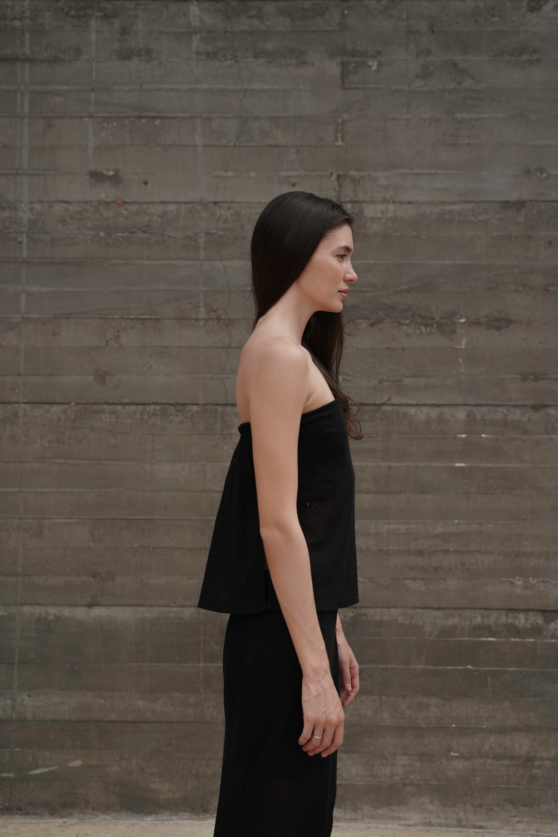 Bandeau Top Lace — side profile, concrete wall